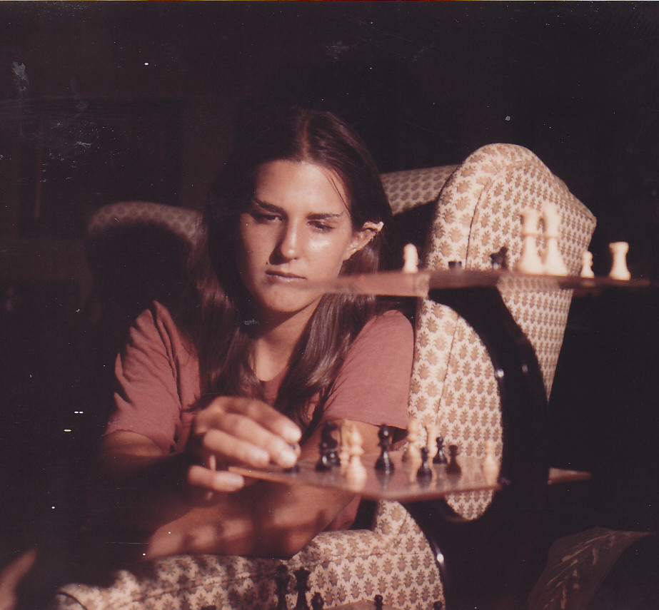 A staged picture of Liz Danforth (teenaged) with Spock-ears and eyebrows, playing 3D chess.