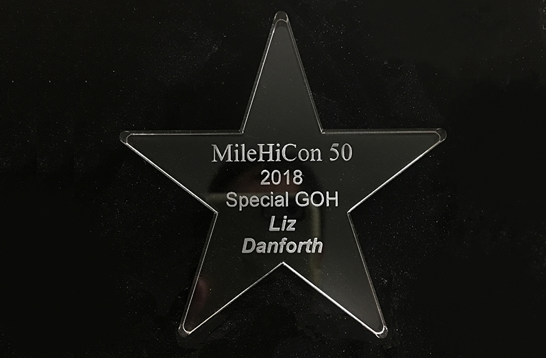 A clear Lucite star commemorating MileHiCon 50, 2018, Special GOH Liz Danforth.